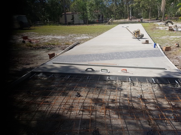 A formed slab with steel reinforcing mesh laid out ready for a pour