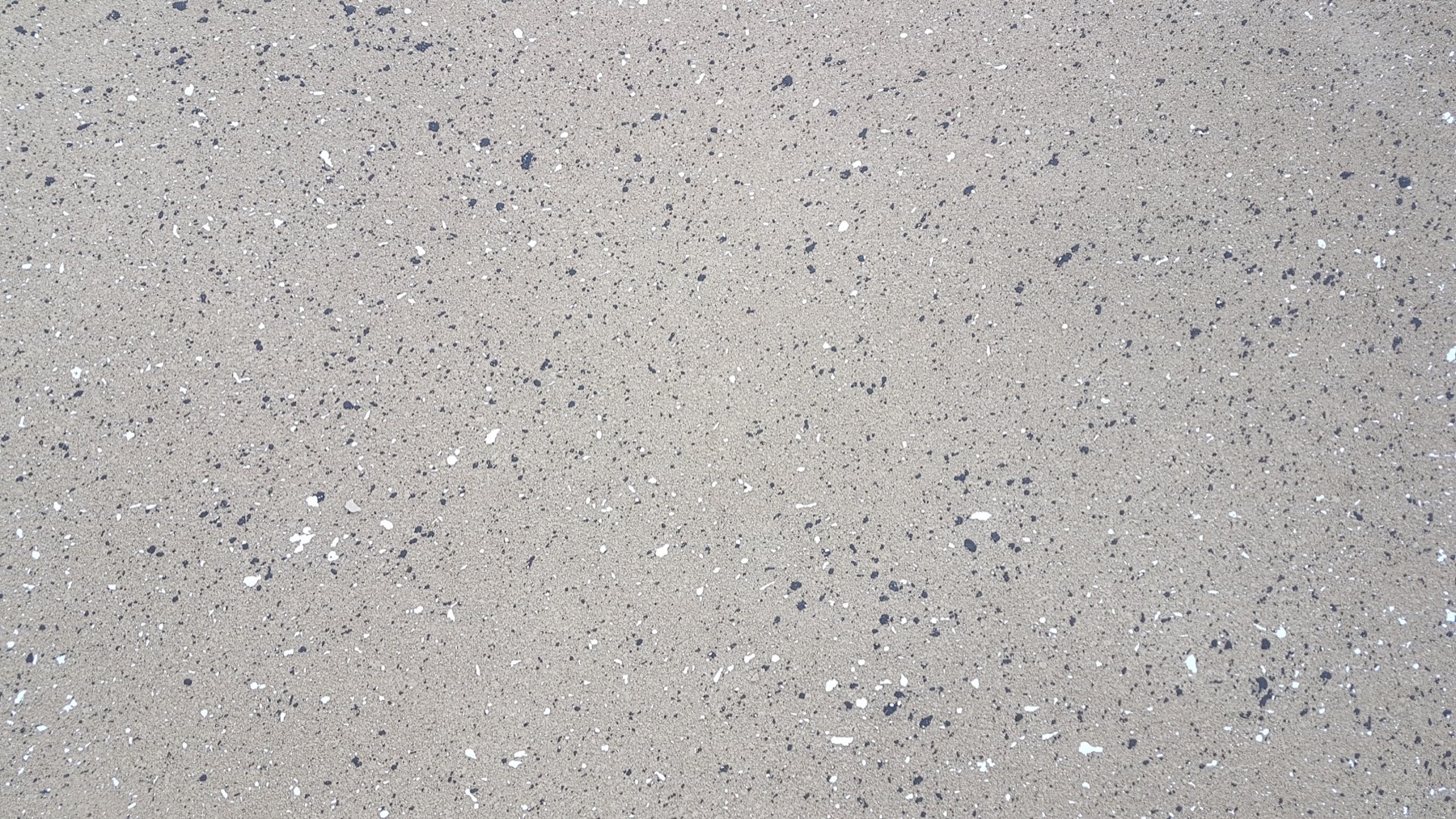 A close view of a washed exposed aggregate concrete surface